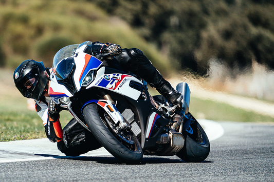 Rider on a BMW motorcycle on a track with blurred background